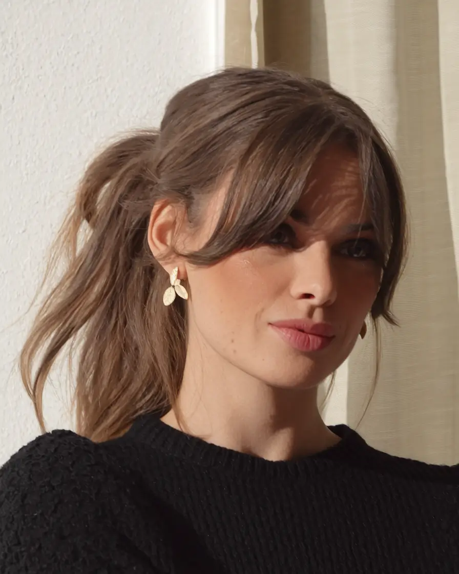 fall brunette hair color balayage Playful Ponytail with Wispy Curtain Fringe
