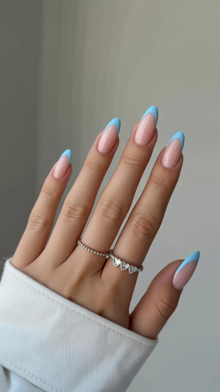 trendy French nails 2026 Pastel Blue French Tips With a Soft Almond Shape