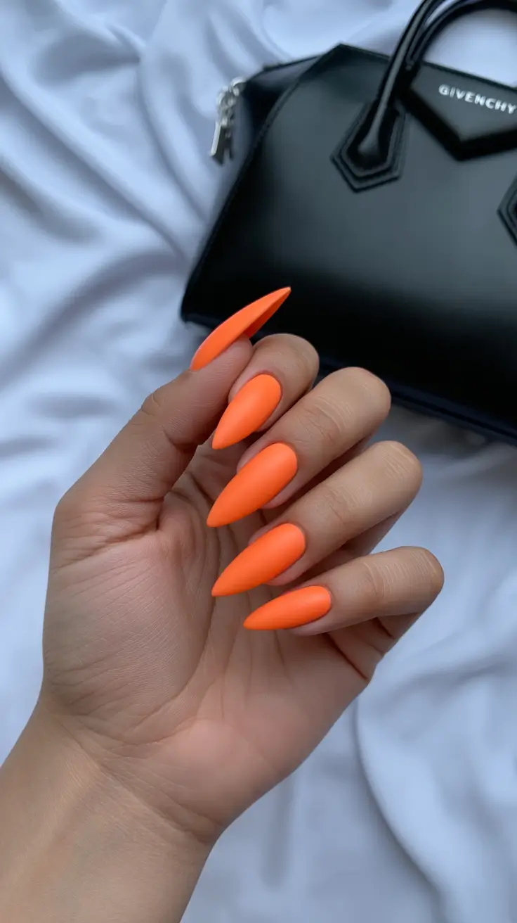 top spring nail colors 2026 Neon Tangerine Matte Stiletto