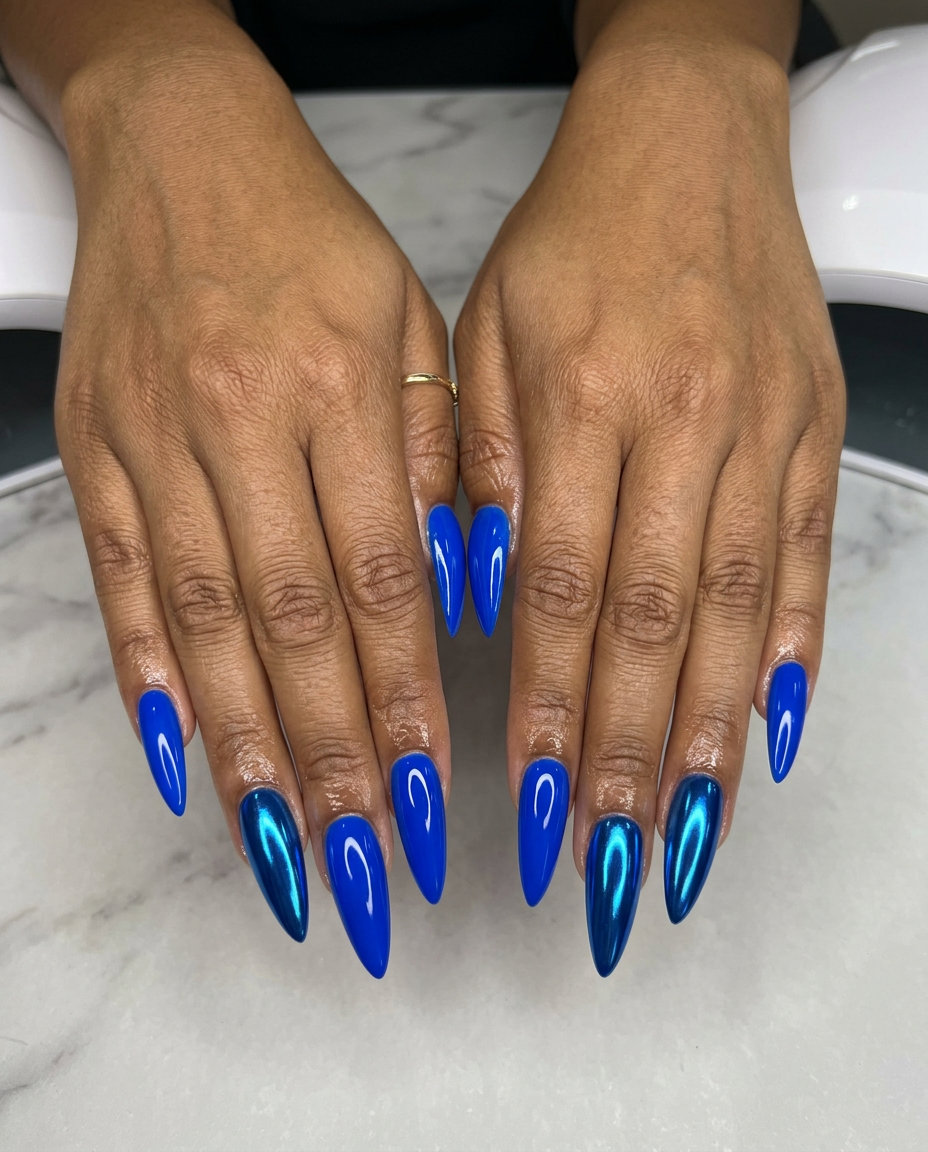 Bold chrome contrast blue nails for july nails 2026: stiletto with glossy blue & electric blue chrome accent.