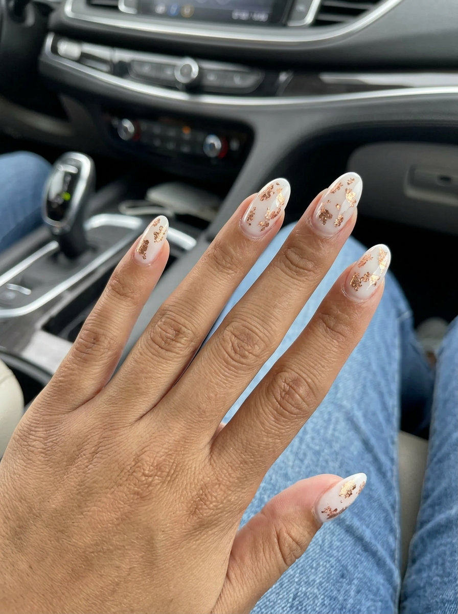 Rose Gold Shimmer Flakes Oval Summer Nails 2026 Oval summer nails 2026: Milky white base with scattered rose gold foil flakes for a glamorous, sparkling look.