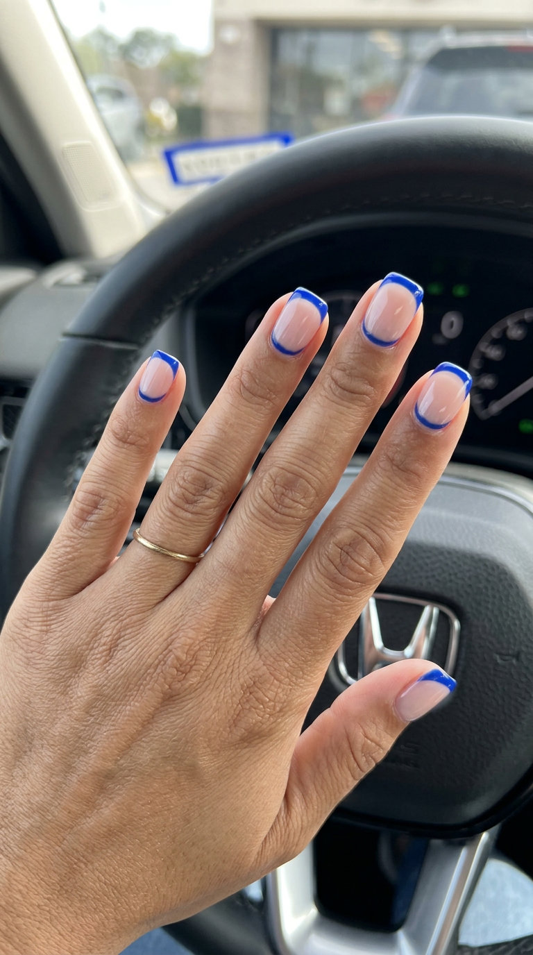 Short summer nails 2026: Cobalt blue reverse French tips on short square nails for date night or evening events.