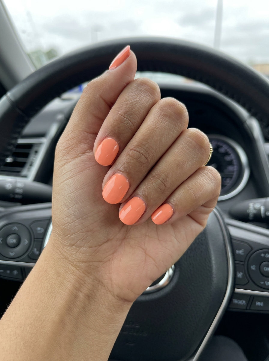 Glossy Light Coral Nails 2026 | Vacation Style Glossy light coral short round nails for vacation and beach trips. Simple short summer nails 2026.