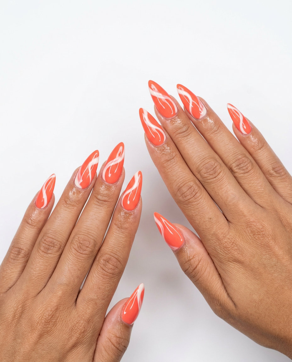 Abstract Coral Stiletto Summer Nails 2026 | Creative Event Artistic vivid coral stiletto summer nails 2026 with creamy white abstract swirls.