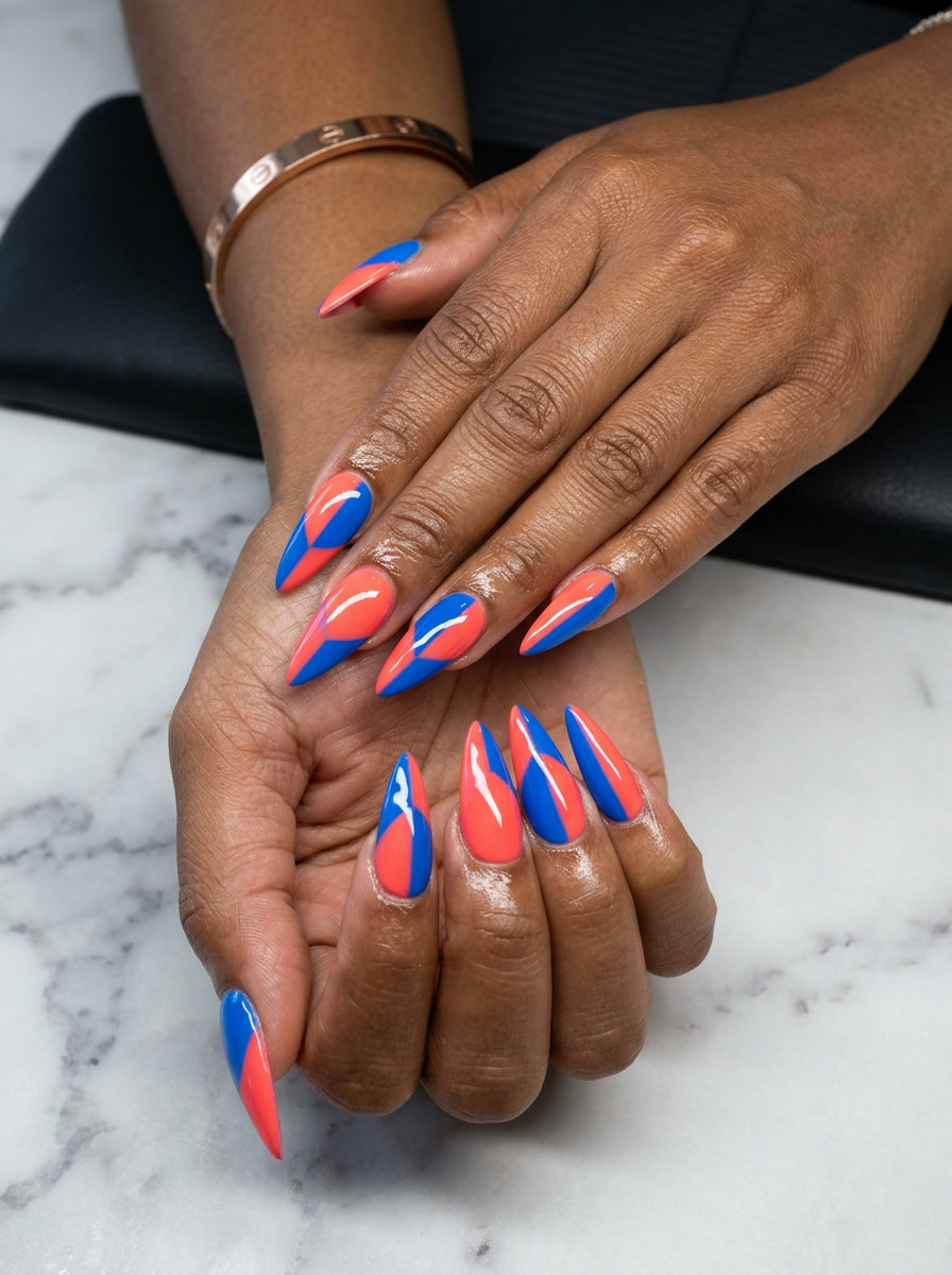 Coral & Blue Stiletto Summer Nails 2026 | Bold Party Style Edgy color block stiletto summer nails 2026 in vivid coral and electric blue.