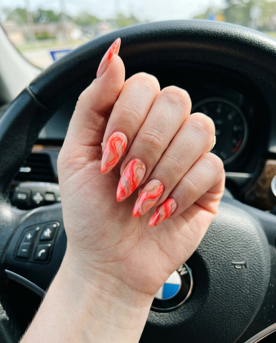 Marble Coral Nude Stilettos 2026 Abstract marble stiletto nails in coral and nude for summer brunch. Stiletto summer nails 2026.