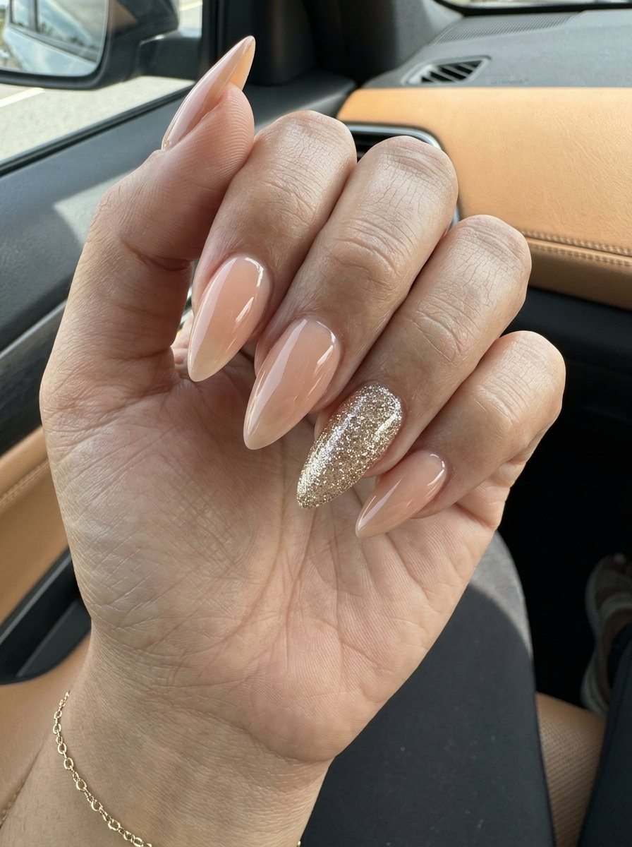 Glamorous Nude Stiletto Summer Nails 2026 | Party Ready Glamorous nude stiletto summer nails 2026 with sparkling champagne glitter accent.