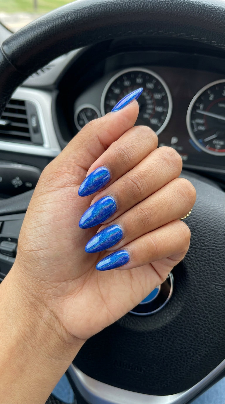 Cobalt Blue Chrome Nails 2026: Futuristic Glam Cobalt blue chrome effect stiletto nails for parties and festivals. Summer dip nails 2026.