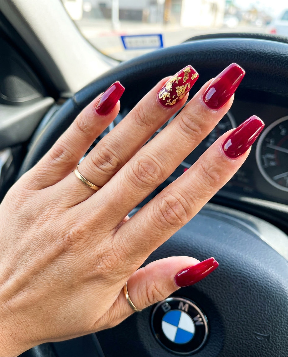 Glamorous ruby red and gold foil nails for summer red nails 2026 party outfits.