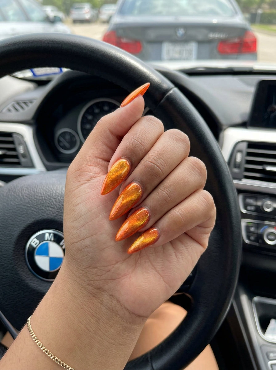 Coral Cat-Eye Nails 2026 | Glamorous Date Night Vibrant coral glossy cat-eye nails for summer vibes 2026, ideal for date nights and parties.