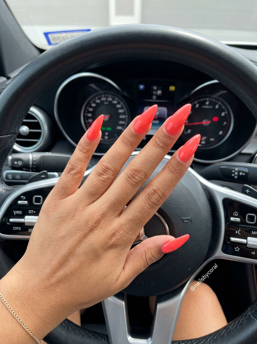 Trendy Summer Nails 2026: Vivid Coral Stiletto Vivid coral solid stiletto nails for trendy summer nails 2026. Glamorous vacation & festival party look.