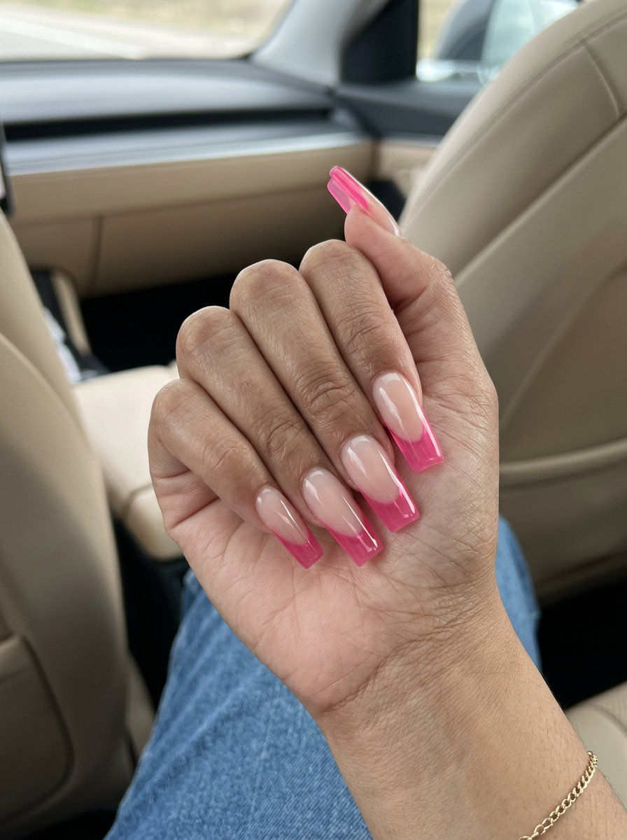 Tropical Nail Designs 2026: Hot Pink Jelly French Hot pink jelly French tip nails for tropical nail designs 2026. Edgy, playful, and bold square nails.