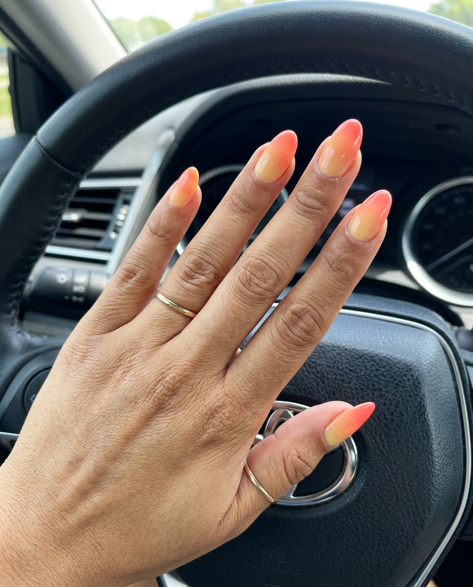 Sunset Aura Gradient Nails 2026: Vacation Vibes Ethereal sunset aura gradient nails in warm yellow, coral, and orange, a vacation tropical nail design 2026.