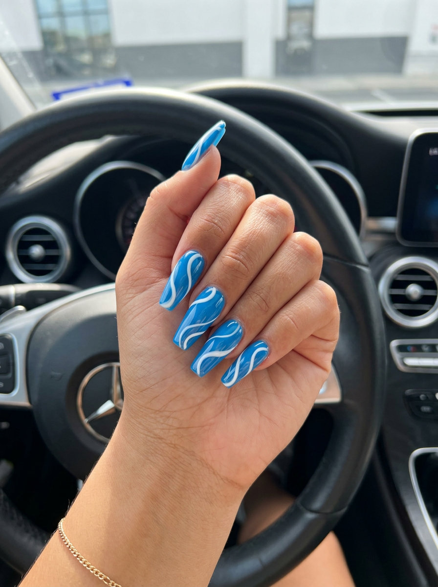 Cobalt Swirl Vacation Nails 2026 Cobalt blue abstract swirl nails for vacation 2026. Sophisticated, artistic, perfect for evenings.