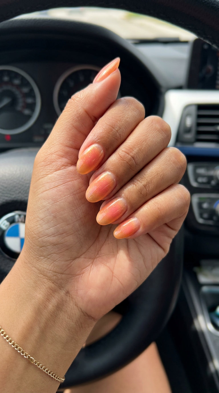 Vacation Nails Summer 2026: Sunset Aura Gradient Sunset Aura Gradient vacation nails summer 2026: romantic peach, orange, pink with gold shimmer on almond nails.