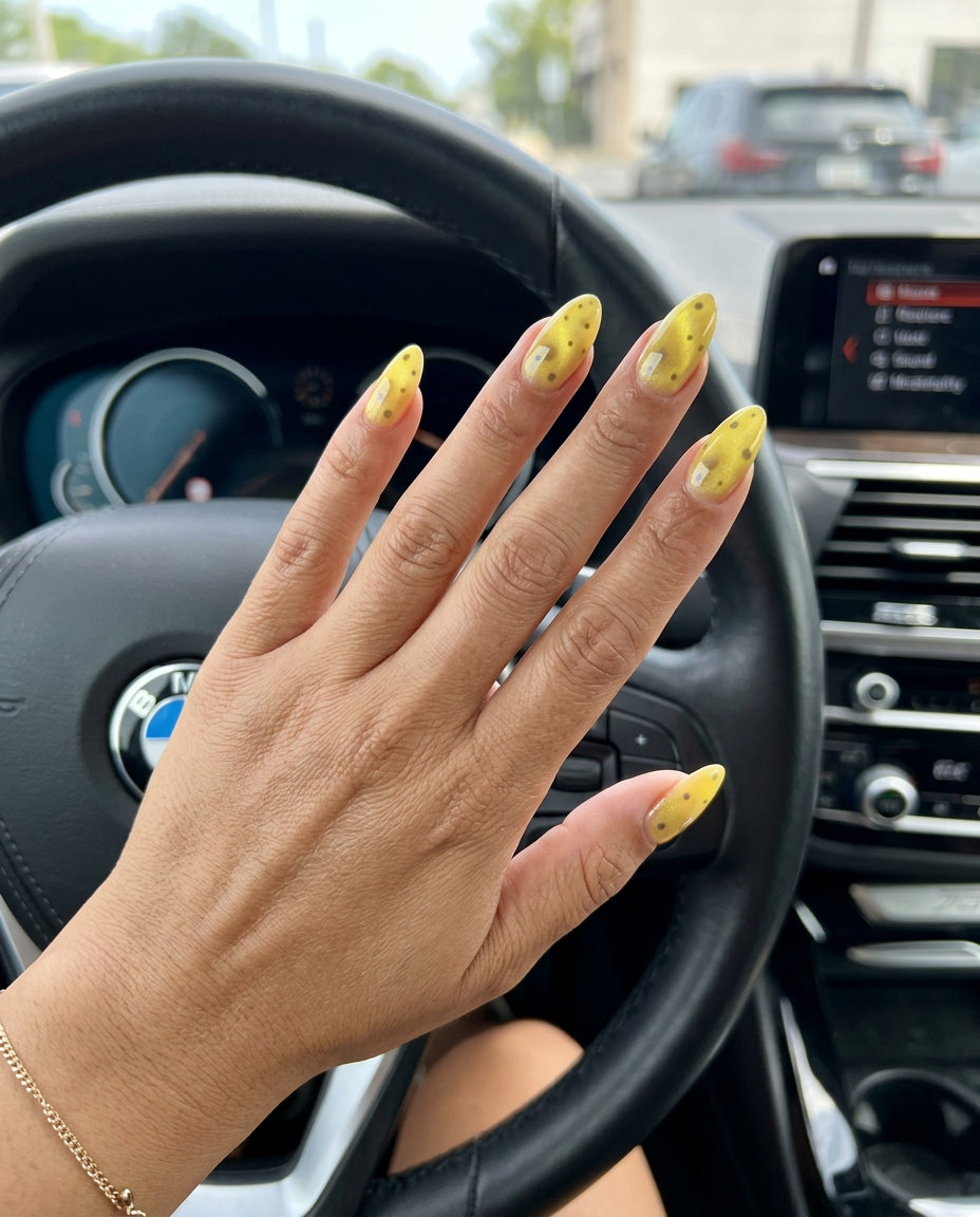 Butter Yellow Cat-Eye Dots Nails 2026 Butter yellow cat-eye almond nails with darker yellow dots for date night or cocktail party. Yellow summer nails 2026.