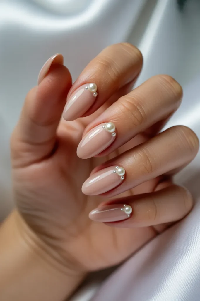 Neutral Beige with Pearl and Rhinestone Accents Neutral Beige with Pearl and Rhinestone Accents — Short almond nails 2027