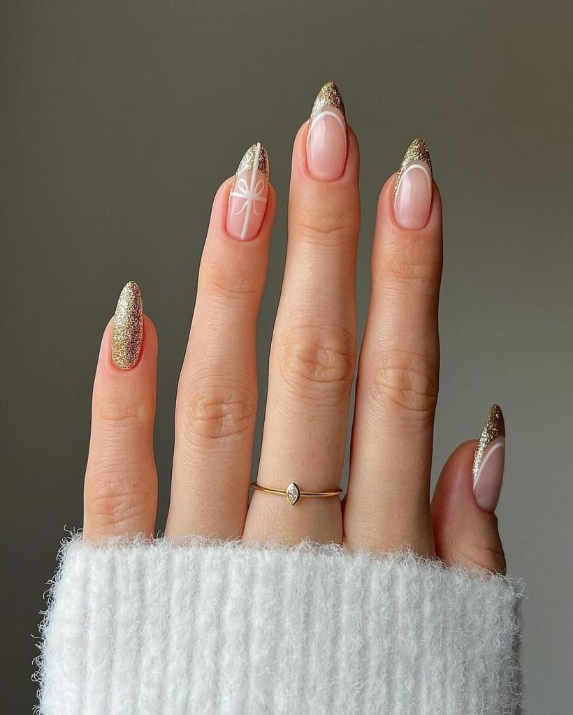 Nude with Gold Glitter and White Bow Nude with Gold Glitter and White Bow — Gold Christmas Nails 2026