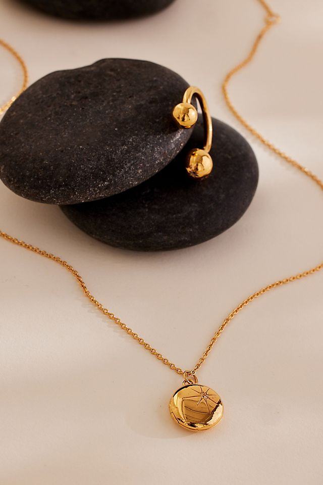 Gold Starburst Pendant Necklace Worn With a Sleeveless Top Gold Starburst Pendant Necklace Worn With a Sleeveless Top — Locket Necklaces 2027