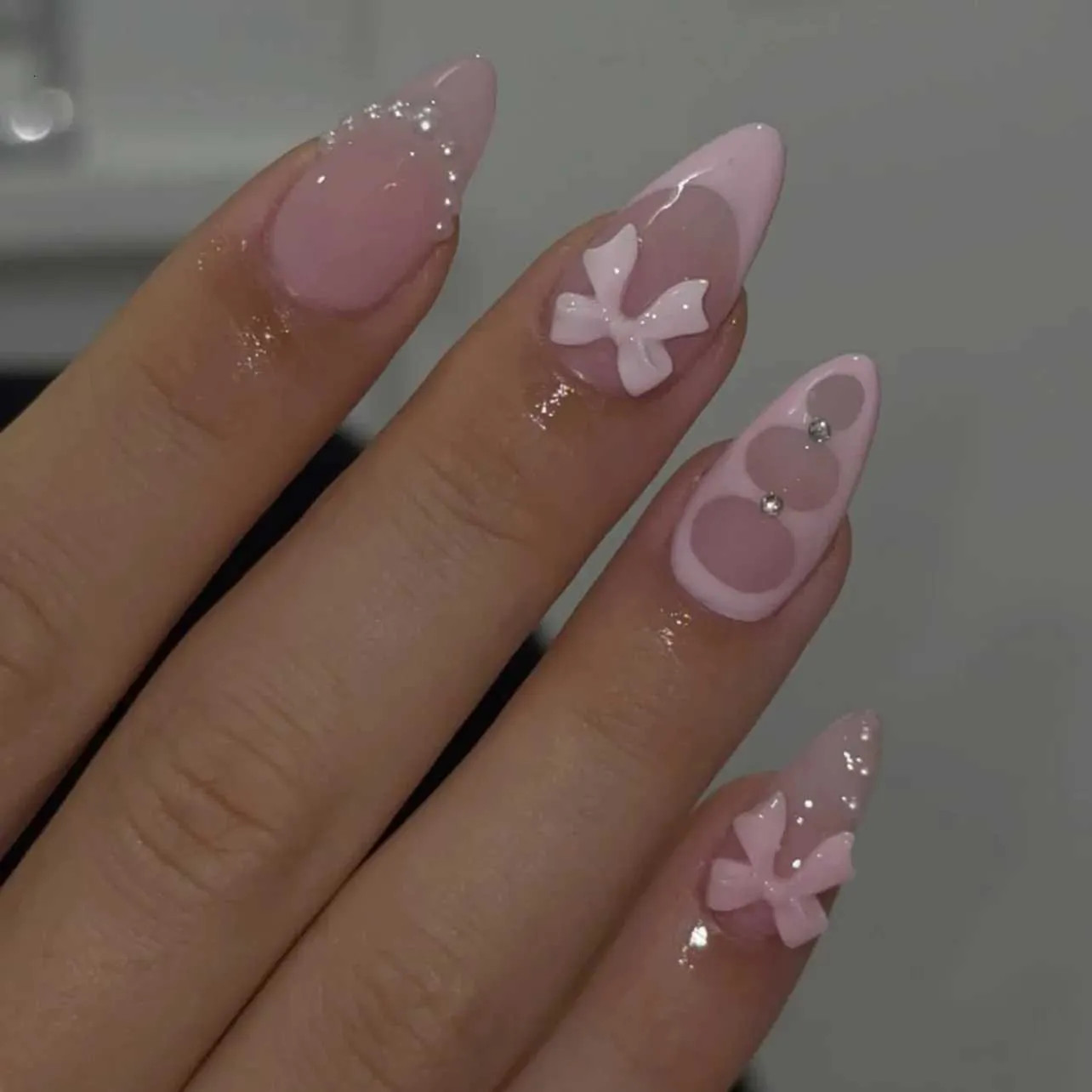 Pale Pink Stilettos with 3D Pink Bows and Glitter — A Clear Glitter Finish Covers The Nails Pale Pink Stilettos with 3D Pink Bows and Glitter — A Clear Glitter Finish Covers The Nails — Bow Stiletto Nails 2027