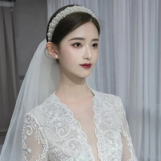 Visual Idea — Her Hair Is Styled In A Classic Updo Visual Idea — Her Hair Is Styled In A Classic Updo — Pearl Headband Hairstyles 2027