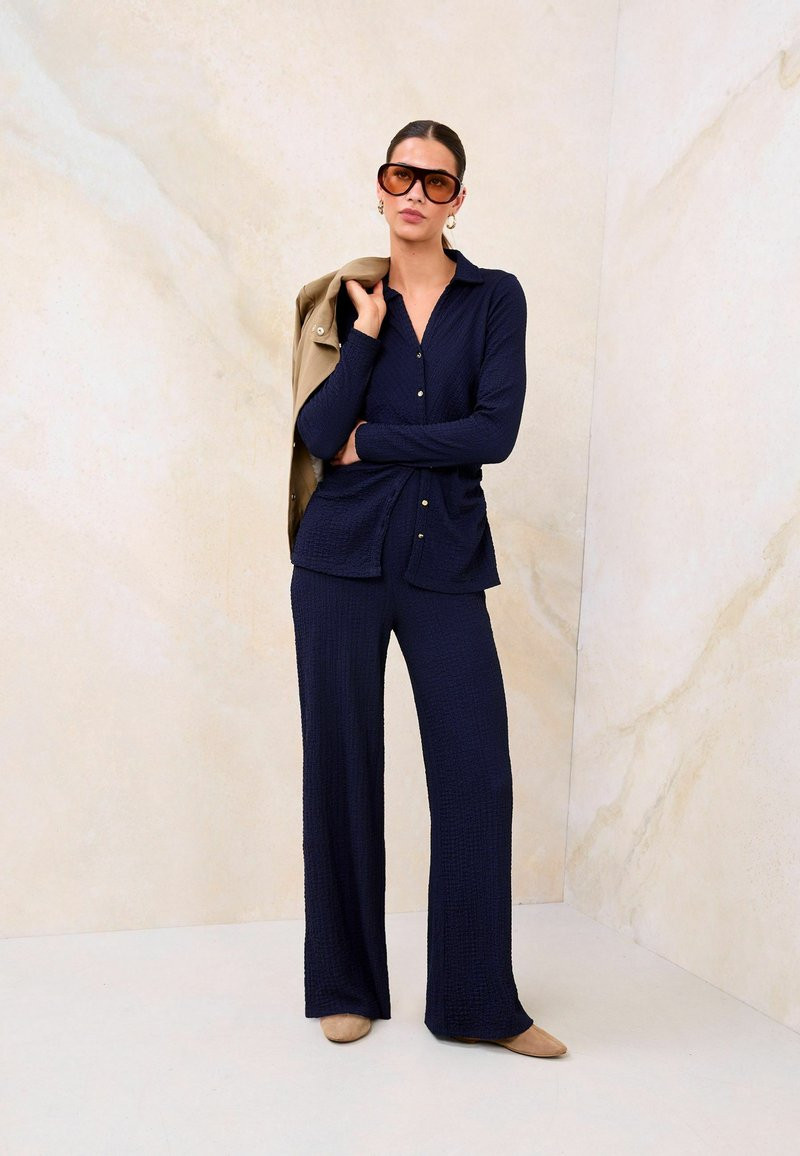 Textured Knit Set: Navy Wide-Leg Pants with Collared Shirt and Tan Jacket Textured Knit Set: Navy Wide-Leg Pants with Collared Shirt and Tan Jacket — Navy Blue Wide Leg Pants Outfits 2027