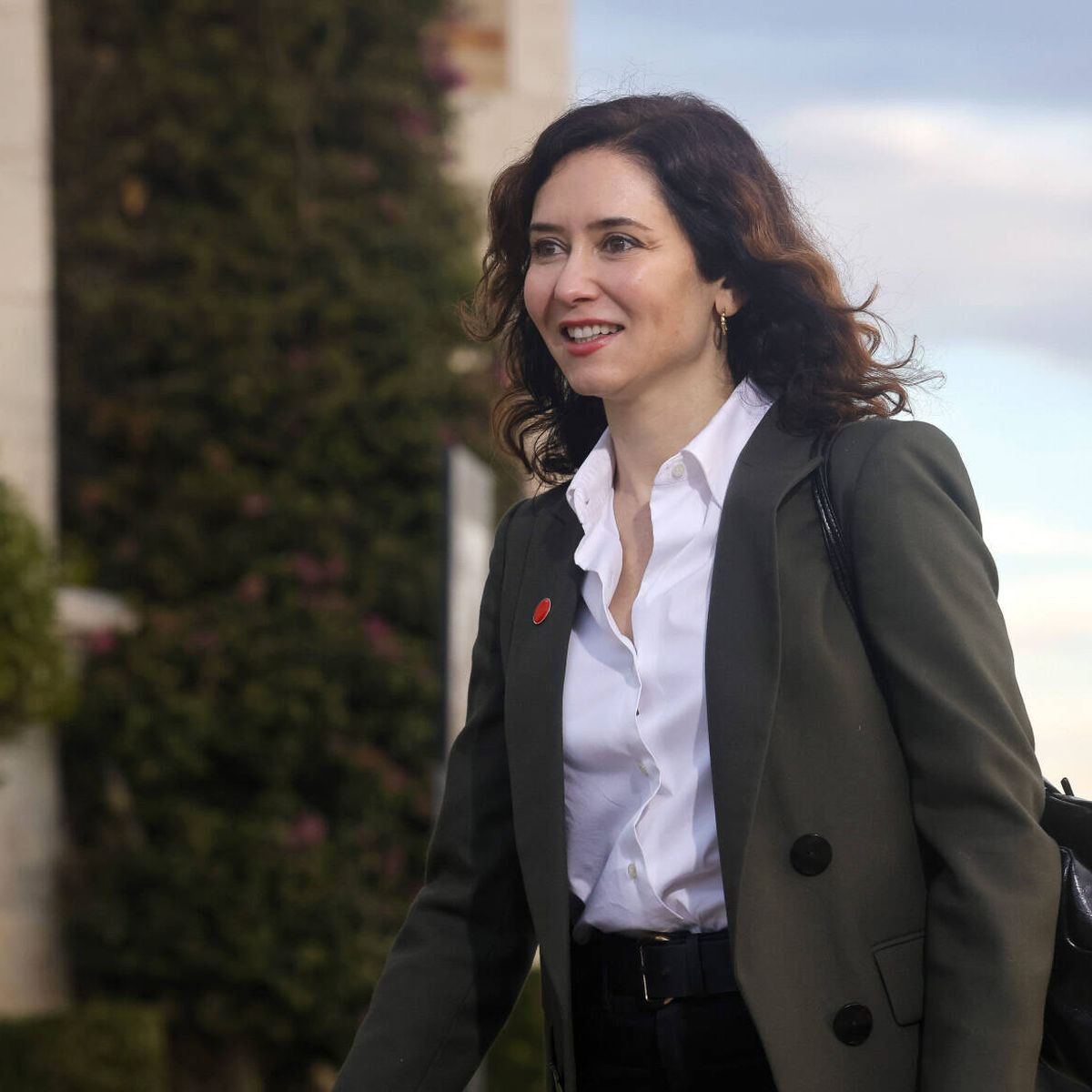 Dark Green Blazer with White Shirt and Red Lapel Pin Dark Green Blazer with White Shirt and Red Lapel Pin — Conference Outfits 2027