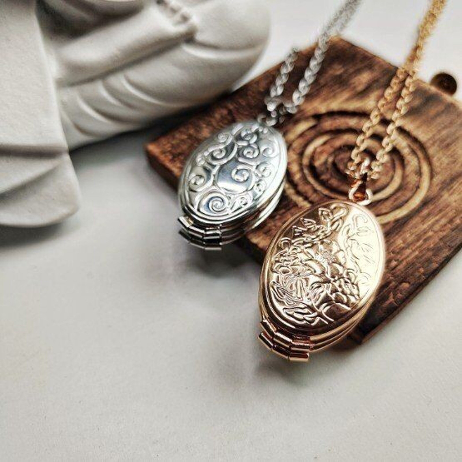 Ornate Embossed Gold and Silver Lockets on Display Ornate Embossed Gold and Silver Lockets on Display — Locket Necklaces 2027