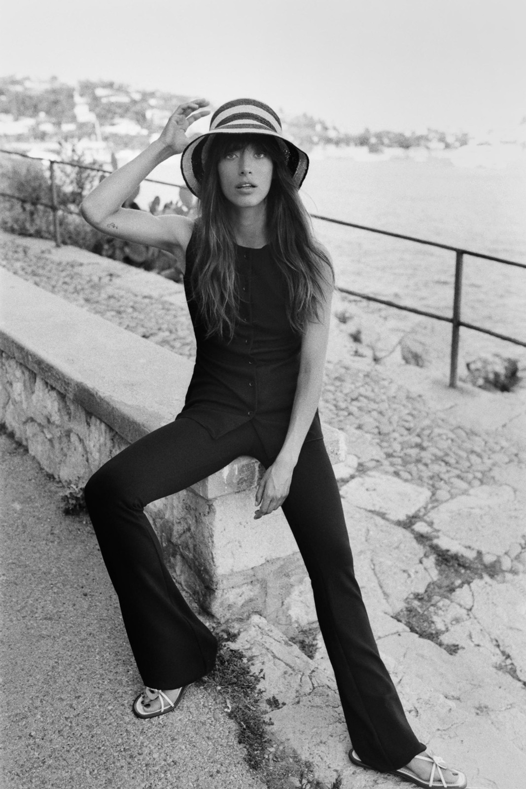 Casual Comfort: Black Flare Leggings with Vest and Striped Hat Casual Comfort: Black Flare Leggings with Vest and Striped Hat — Flare Leggings Outfits 2027