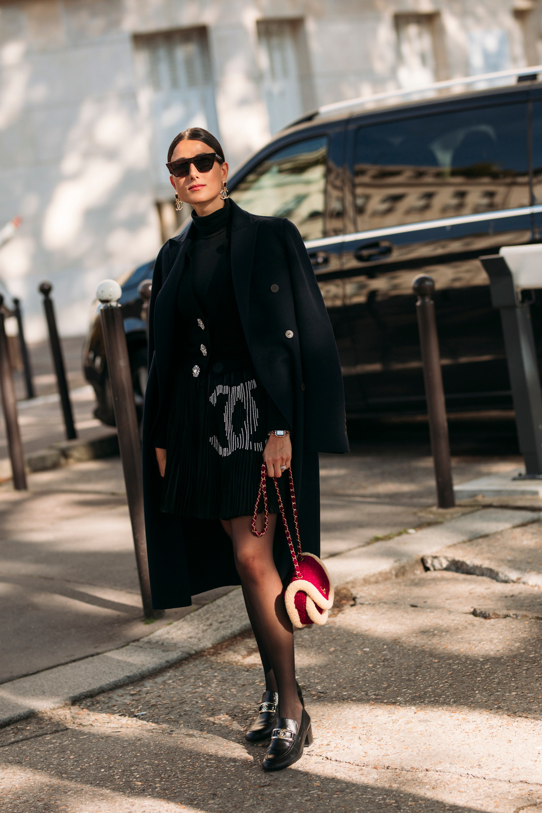 Navy Coat Draped Over Black Turtleneck and Embellished Mini Skirt Navy Coat Draped Over Black Turtleneck and Embellished Mini Skirt — Winter Neutral Outfits 2027