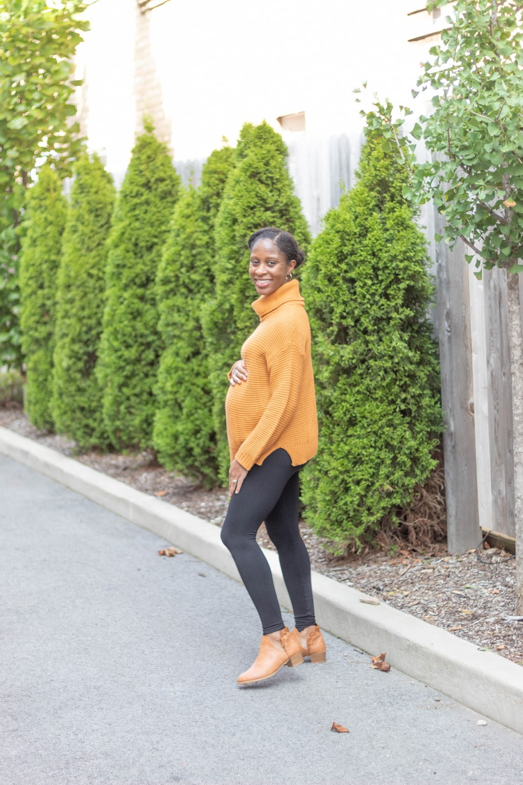 Cozy Maternity Style: Orange Turtleneck Sweater with Black Leggings Cozy Maternity Style: Orange Turtleneck Sweater with Black Leggings — Maternity Outfits 2027