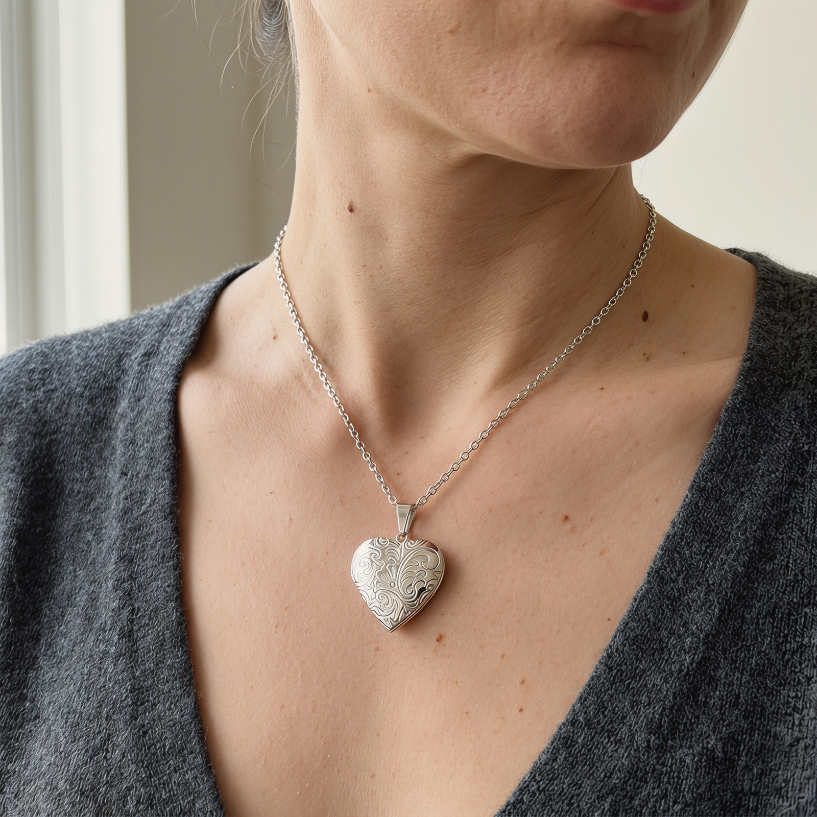 Grey Knit Cardigan Worn with an Ornate Engraved Silver Locket Grey Knit Cardigan Worn with an Ornate Engraved Silver Locket — Locket Necklaces 2027