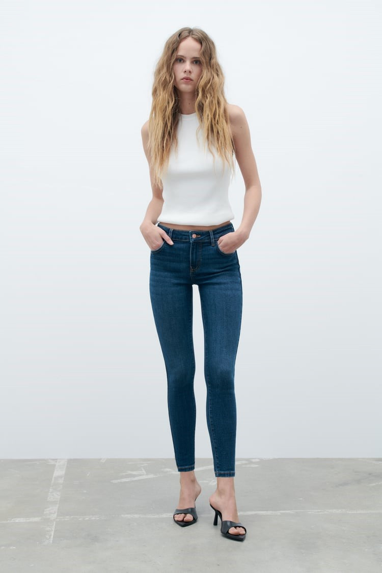 Dark Blue Skinny Jeans with White Sleeveless Top and Heeled Mules — Scene Skinny Jeans Outfits 2027