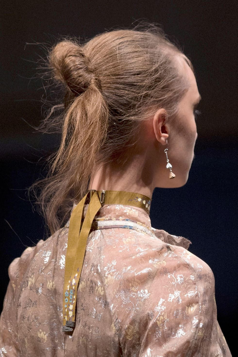 Visual Idea — Loose Strands Frame The Face Visual Idea — Loose Strands Frame The Face — Messy Bun 2027