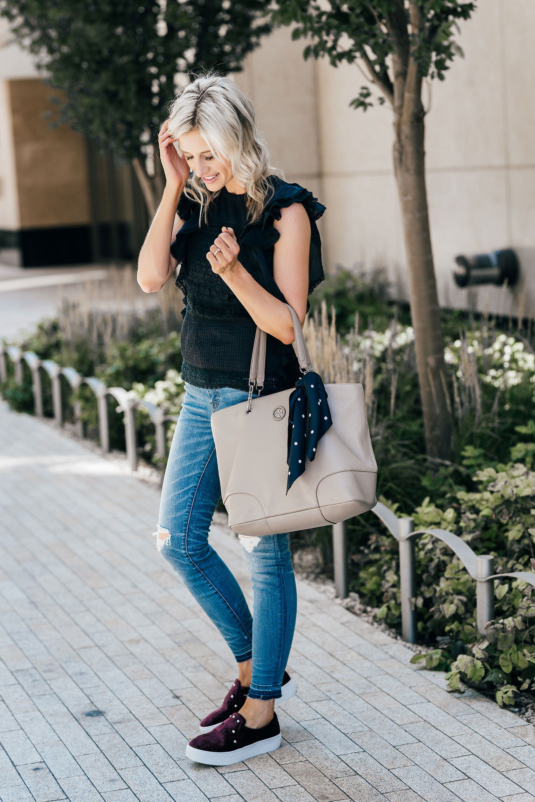 Ruffled Edge: Black Top with Distressed Jeans and Studded Sneakers for Anniversary Ruffled Edge: Black Top with Distressed Jeans and Studded Sneakers for Anniversary — Anniversary Outfits 2027
