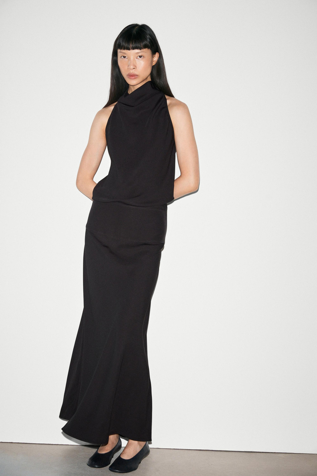 Black Sleeveless Mock-Neck Dress: Sleek Professionalism with a Dramatic Neckline Black Sleeveless Mock-Neck Dress: Sleek Professionalism with a Dramatic Neckline — Business Professional Outfits 2027