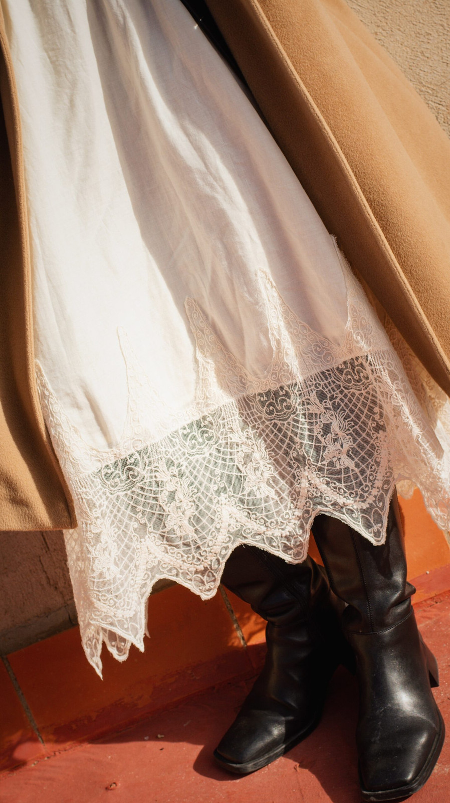 White Lace Slip Skirt Under Camel Coat with Leather Boots — Slip Skirt Outfits 2027