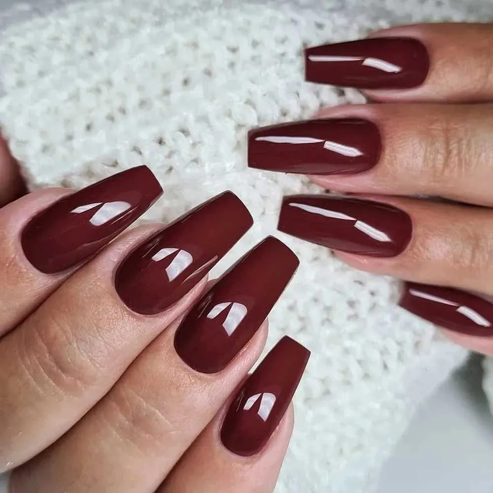 Deep Glossy Burgundy Coffin Nails — The Hands Are Shown With A White Deep Glossy Burgundy Coffin Nails — The Hands Are Shown With A White — Gothic Coffin Nails 2027