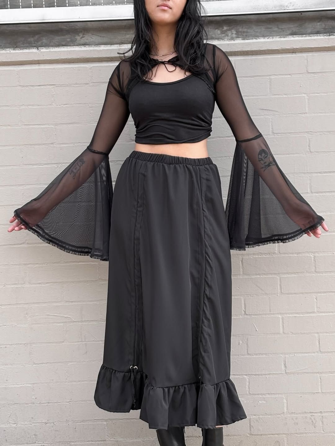 Black Mesh Top With Ruffled Skirt and Boots — Mesh Top Outfits 2027