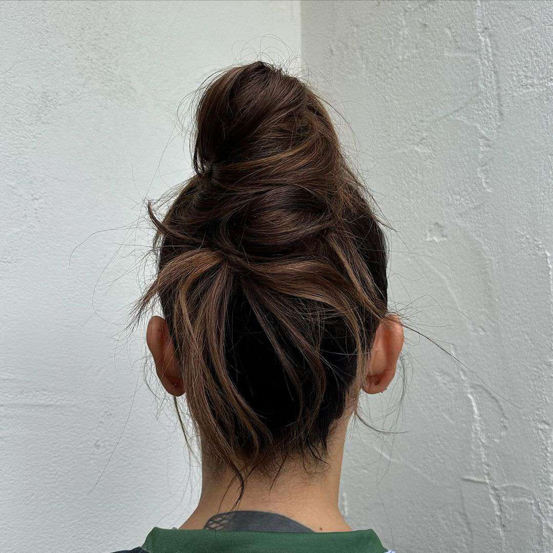 Loose Messy Bun With Subtle Highlights Loose Messy Bun With Subtle Highlights — Hairstyles 2027 for Hot Weather