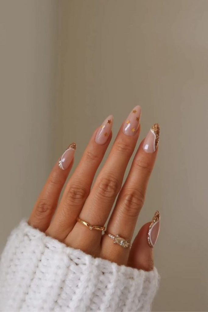 Nude with Gold Glitter French Tips and Stars Nude with Gold Glitter French Tips and Stars — Gold Christmas Nails 2026