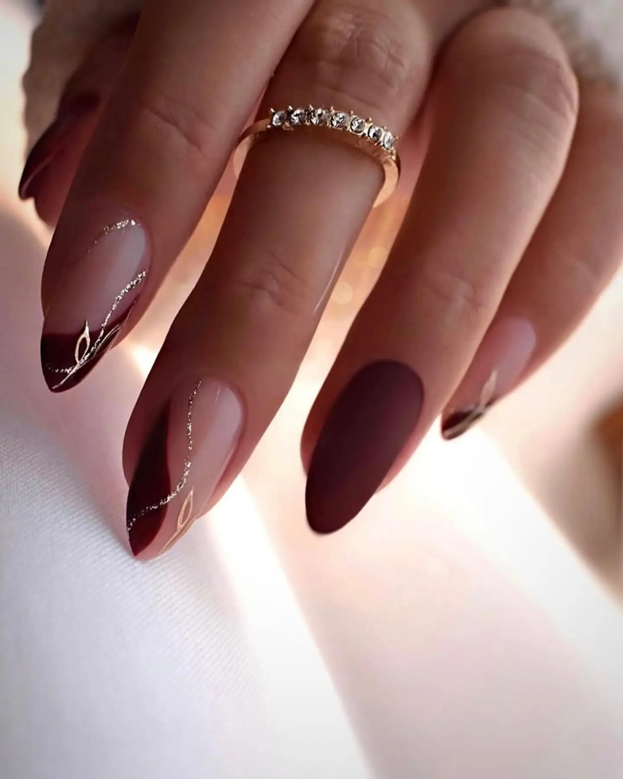 Visual Idea — The Hand Is Posed Against A Soft Visual Idea — The Hand Is Posed Against A Soft — Burgundy Christmas Nails 2026