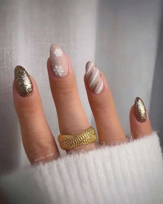 Glitter Opaque Nude with Gold Glitter and White Snowflakes Glitter Opaque Nude with Gold Glitter and White Snowflakes — Gold Christmas Nails 2026