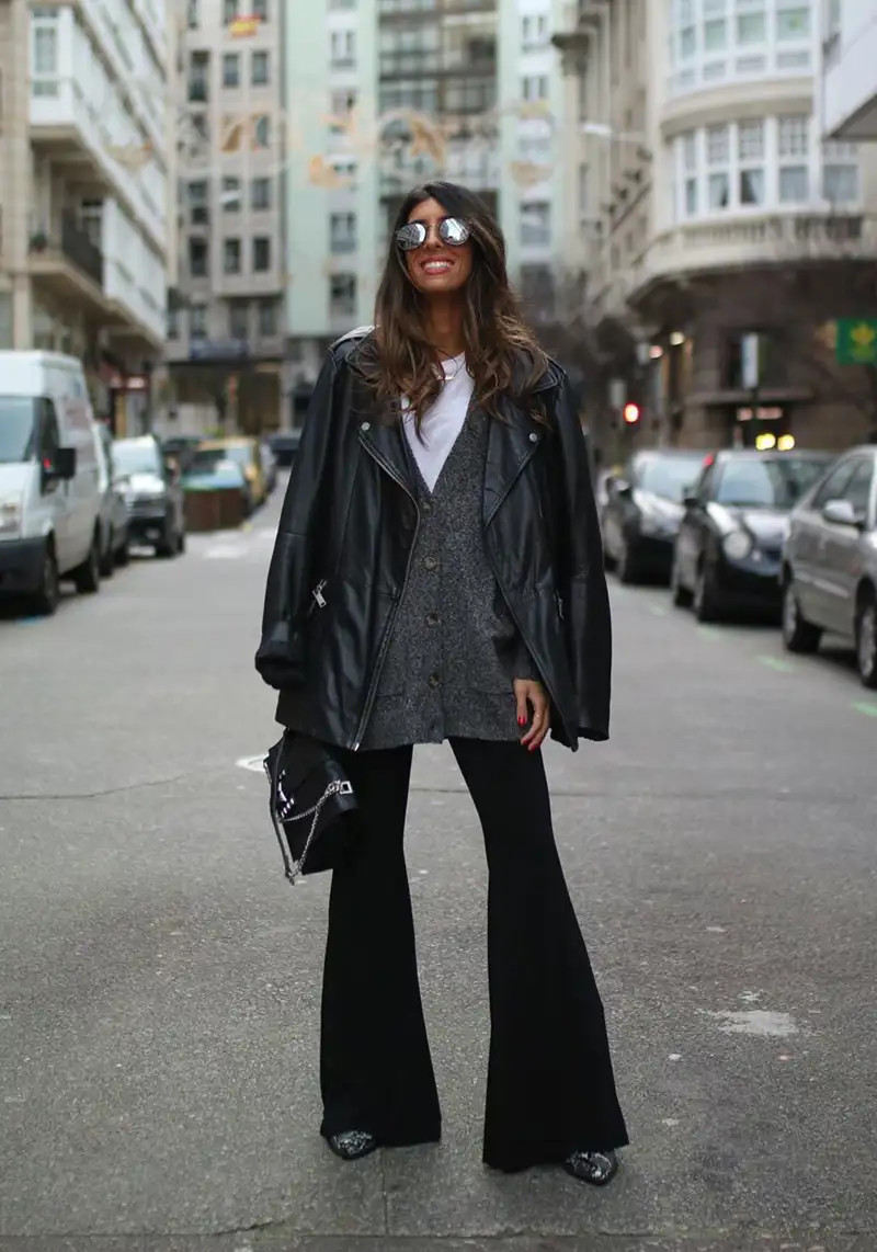 Edgy Street Style: Black Flare Leggings with Leather Jacket and Knit Vest Edgy Street Style: Black Flare Leggings with Leather Jacket and Knit Vest — Flare Leggings Outfits 2027