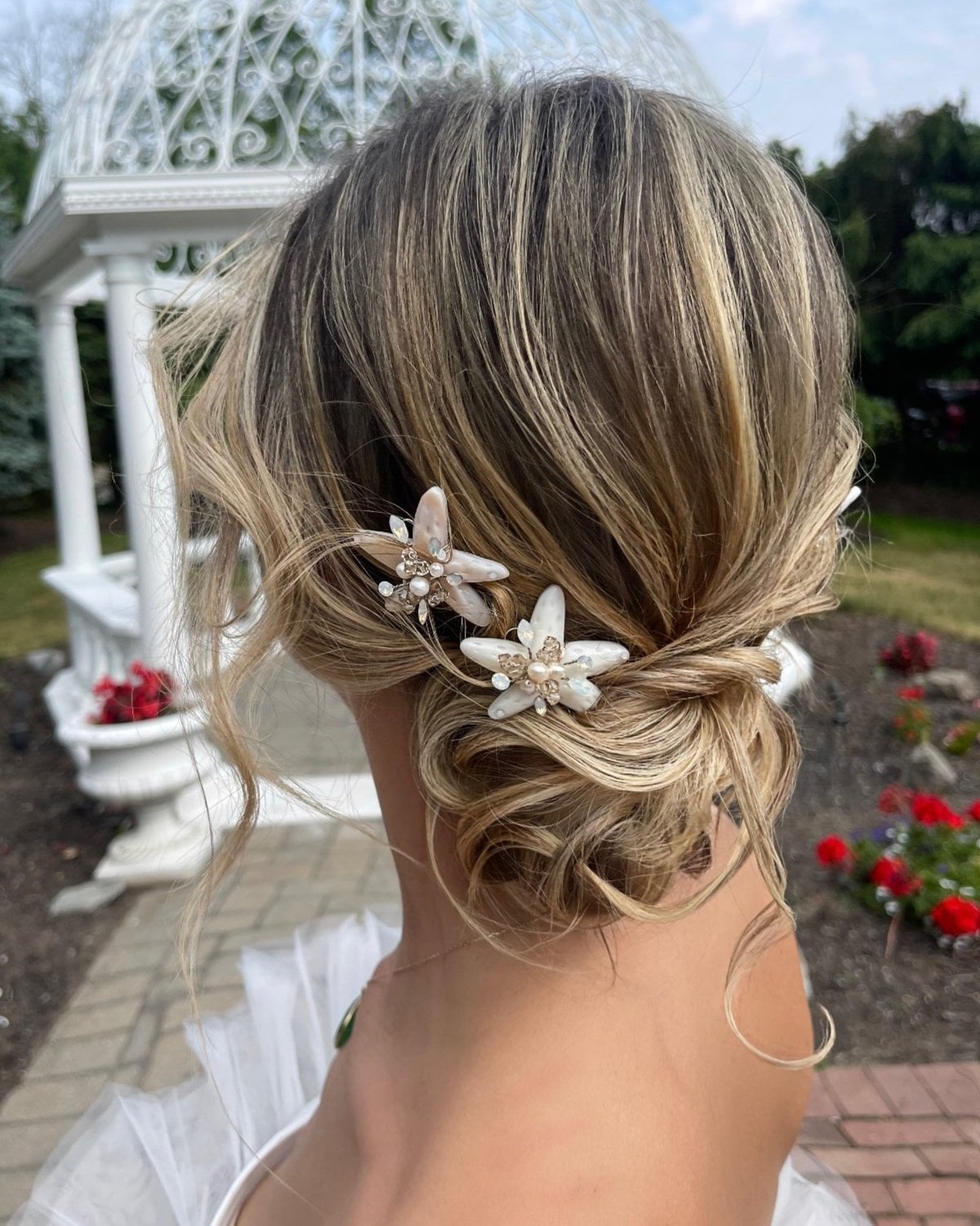 Blonde Low Bun With Wispy Bangs and Starfish Pins Blonde Low Bun With Wispy Bangs and Starfish Pins — Beach Wedding Hairstyles 2027