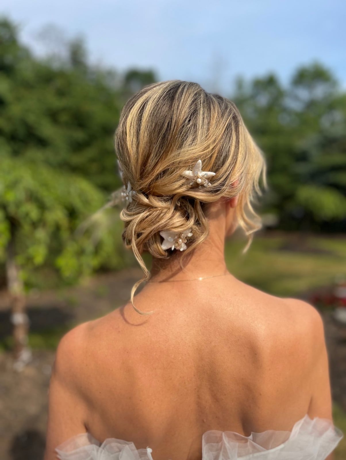 Blonde Updo With Floral and Pearl Accessories Blonde Updo With Floral and Pearl Accessories — Beach Wedding Hairstyles 2027