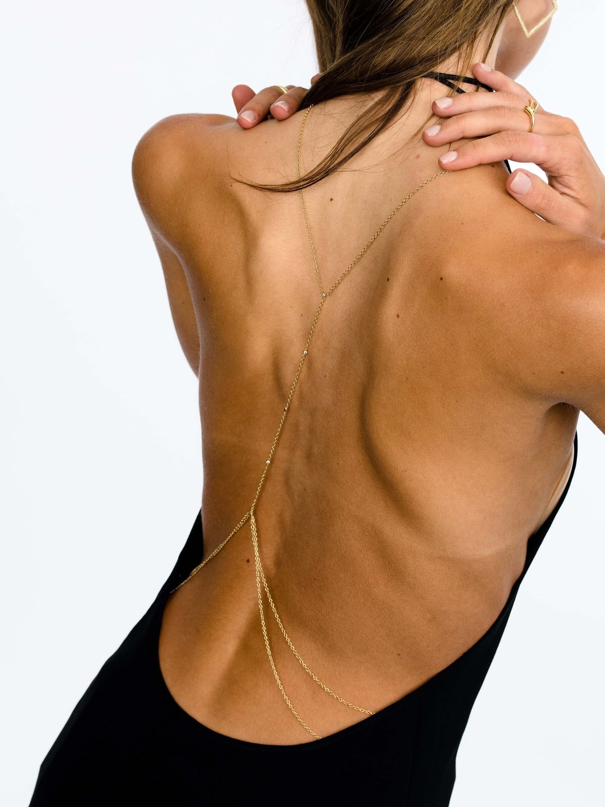 Minimalist gold body chain on black low-back dress Minimalist gold body chain on black low-back dress — Body Chain Outfits 2027