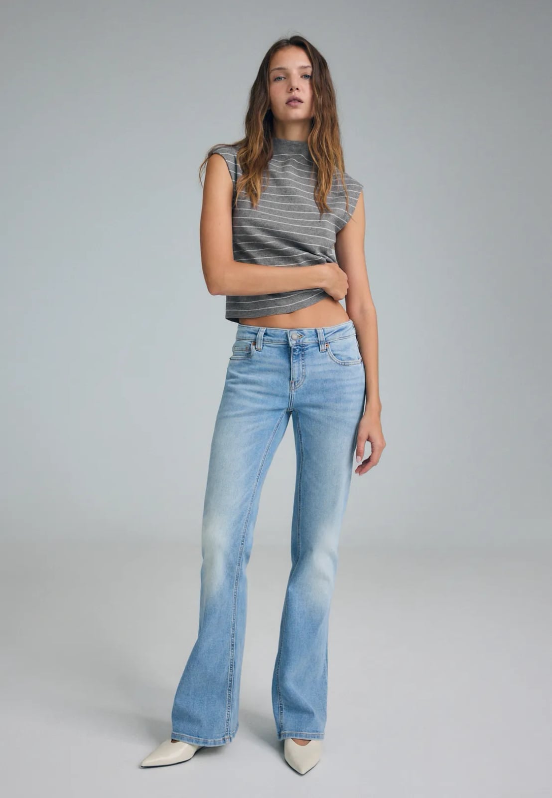 Light Wash Bootcut Jeans With Striped Mock Neck Crop, Close-Up Take Light Wash Bootcut Jeans With Striped Mock Neck Crop, Close-Up Take — Bootcut Jeans Outfits 2027 with Crop Top
