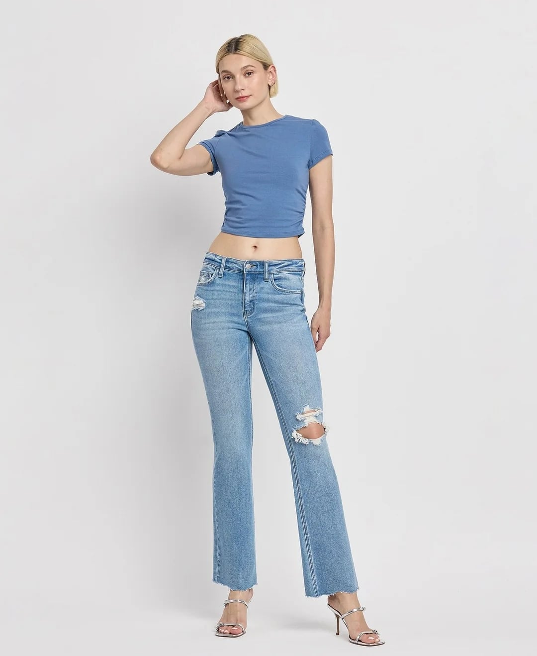Light Blue Bootcut Jeans With Rips And White Crop Top, Strappy Heels Light Blue Bootcut Jeans With Rips And White Crop Top, Strappy Heels — Bootcut Jeans Outfits 2027 with Crop Top