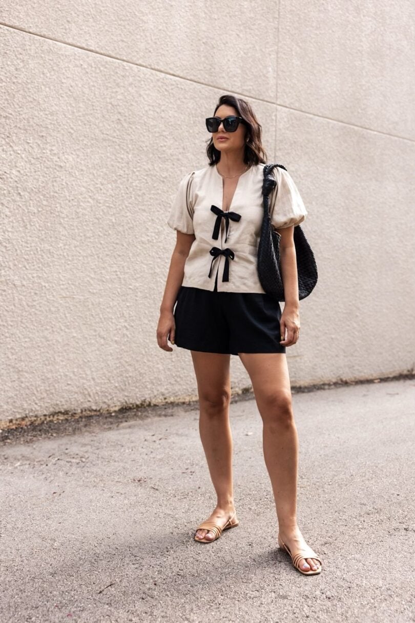 Beige Top With Black Velvet Bows And Shorts, Flat Sandals In Tan Beige Top With Black Velvet Bows And Shorts, Flat Sandals In Tan — Bow Blouse Outfits 2027